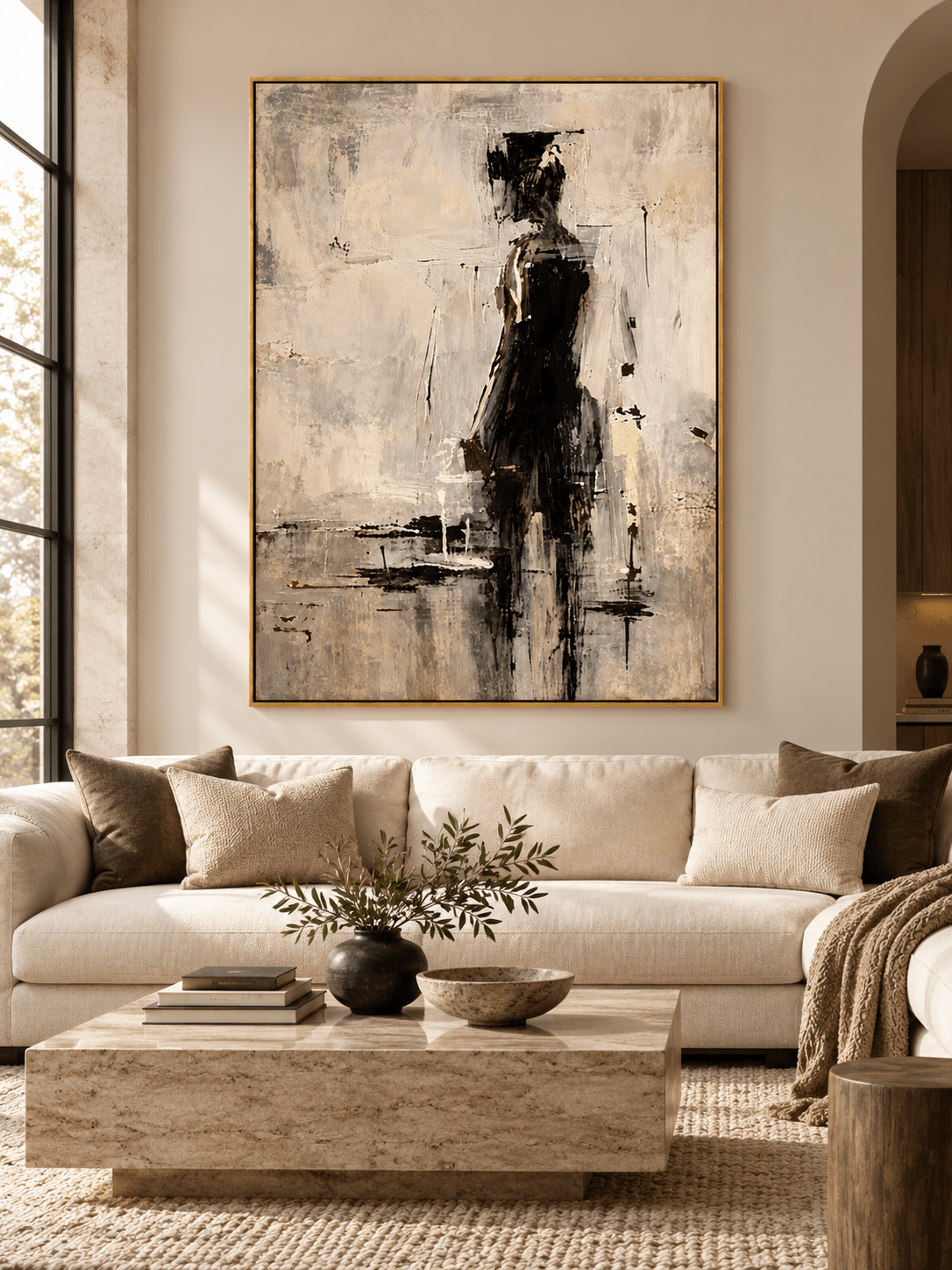 Minimalist abstract woman in black painting displayed in a modern living room with warm neutral decor.