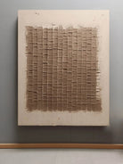 Textured grid wall art displayed in modern living room, showing brown tonal panels in contemporary home decor