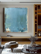 Large blue distressed textured abstract oil painting hand-painted on canvas by Akari Kobayashi, with a floating gold frame on a white background. Perfect for a living room wall.