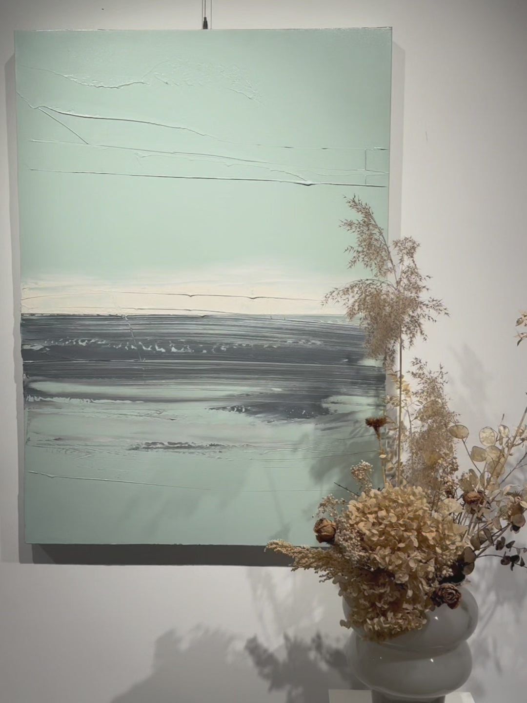 Close-up of textured brushstrokes in abstract black sea painting, showing artist's technique